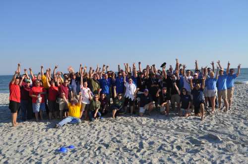 Corporate team celebrates after a Venture Up beach team building event in San Diego, promoting collaboration, diversity, and inclusion.