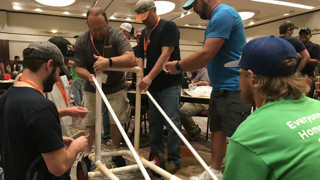 Participants build a pvc race car to compete in a team building race.