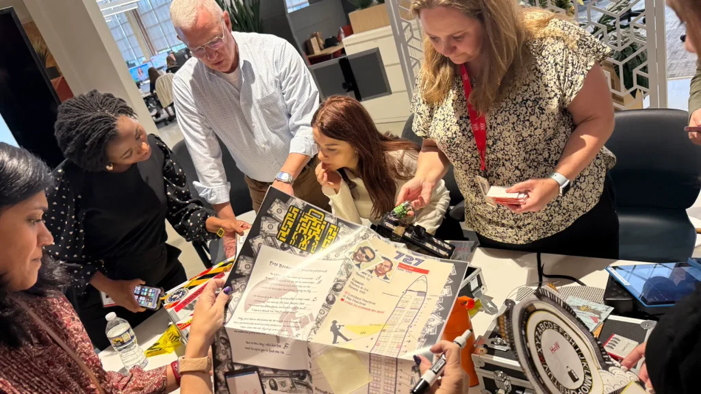 Team solving Escape the Case clues around a tabletop in Durham