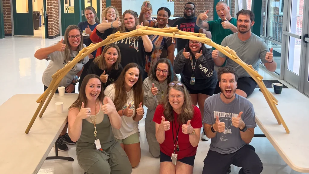 Team celebrating Strategic Games bridge challenge in Durham, North Carolina