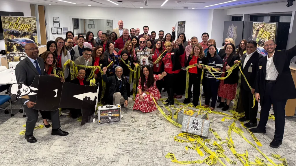 Large group celebrating Escape Case with caution tape in Houston
