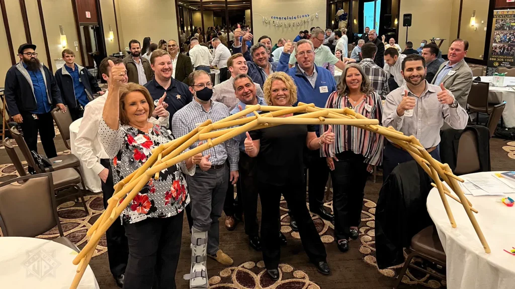 Team celebrating bridge build during Strategic Games in Houston