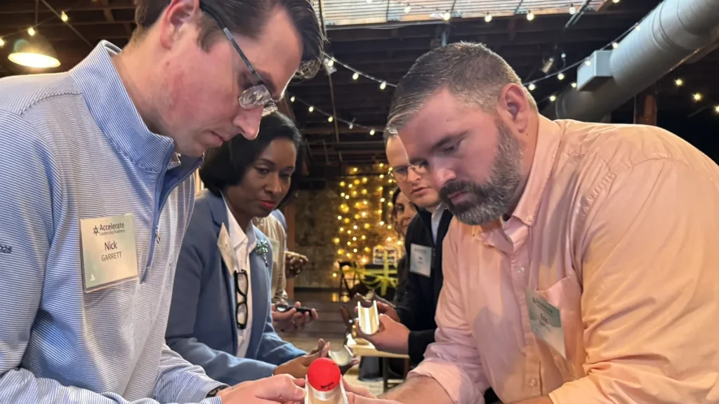 Team members collaborate on a hands-on challenge during Venture Up's Strategic Games team-building activity.