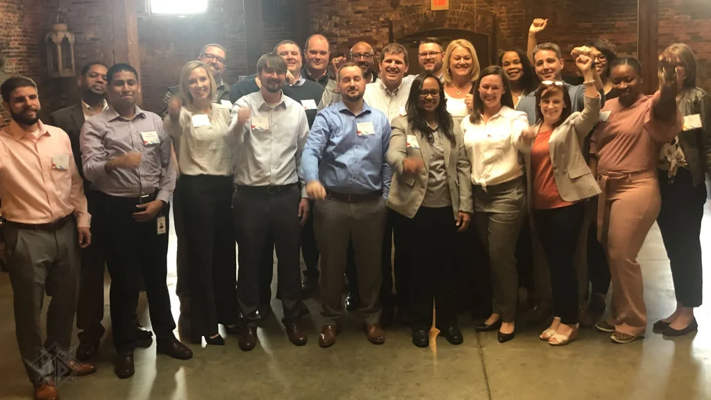 Corporate team celebrates completing Venture Up's Strategic Games team-building program.