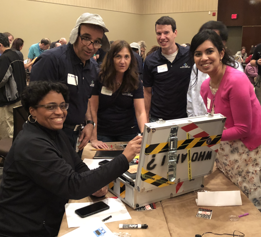 Corporate executives play the Escape Case game, an interactive team building challenge in Houston.