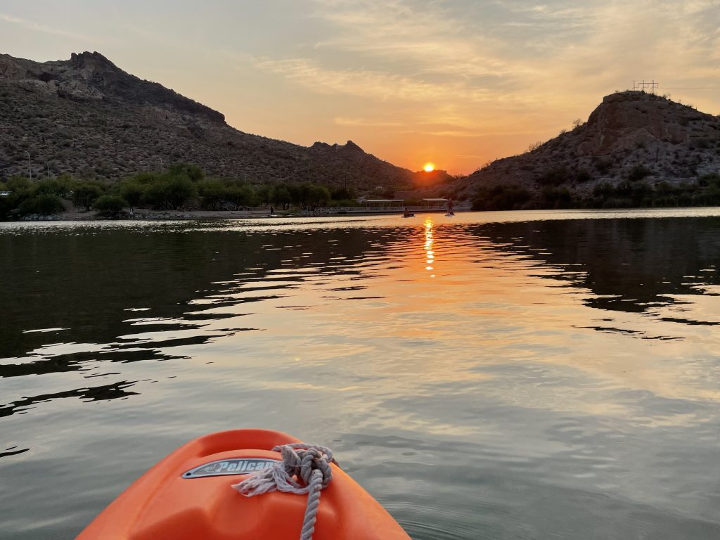 kayak tip facing sunset between two peaks at canyon lake arizona | Team Building Activities & Techniques